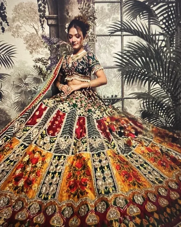 Our signature multi-color lehenga is a perfect choice for a Mehendi or Sangeet. The vibrant panels of yellow, red, and green with heavy embroidery ensure you stand out in every photo.