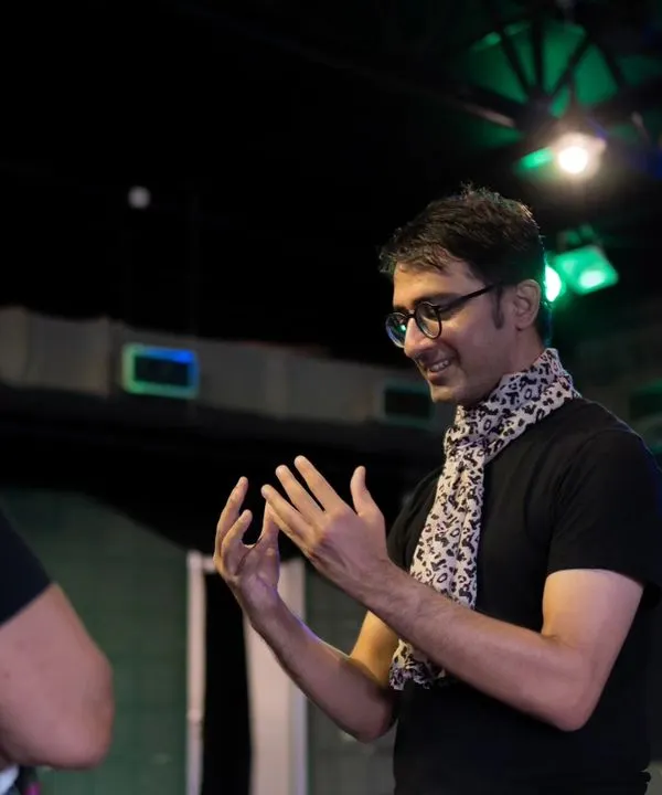 A candid moment of discussion between a facilitator and a participant during a Playback Theatre workshop. This is where ideas are shared and stories begin to take shape.