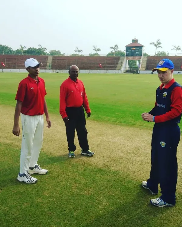 Our Under-19 team captain at the coin toss before a match against the New Zealand youth team. We provide our players with invaluable exposure to international-level competition at professional venues like Ananthapur Stadium.