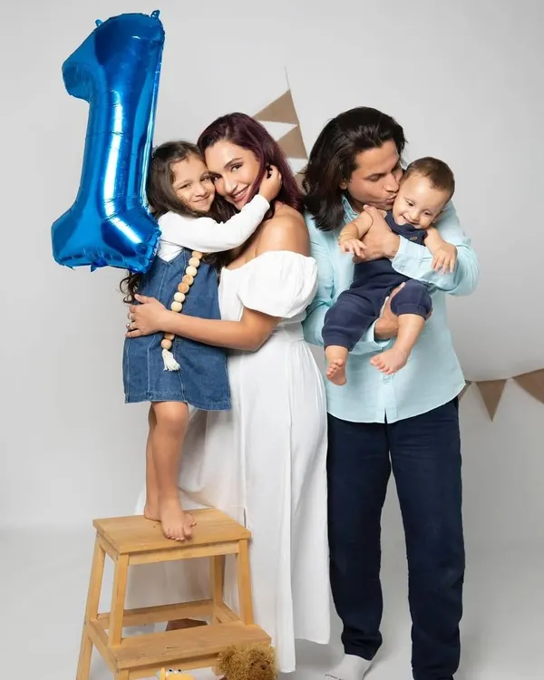 A beautiful family portrait celebrating a first birthday. The love and connection between parents, sister, and the birthday boy are what make this photo so special.
