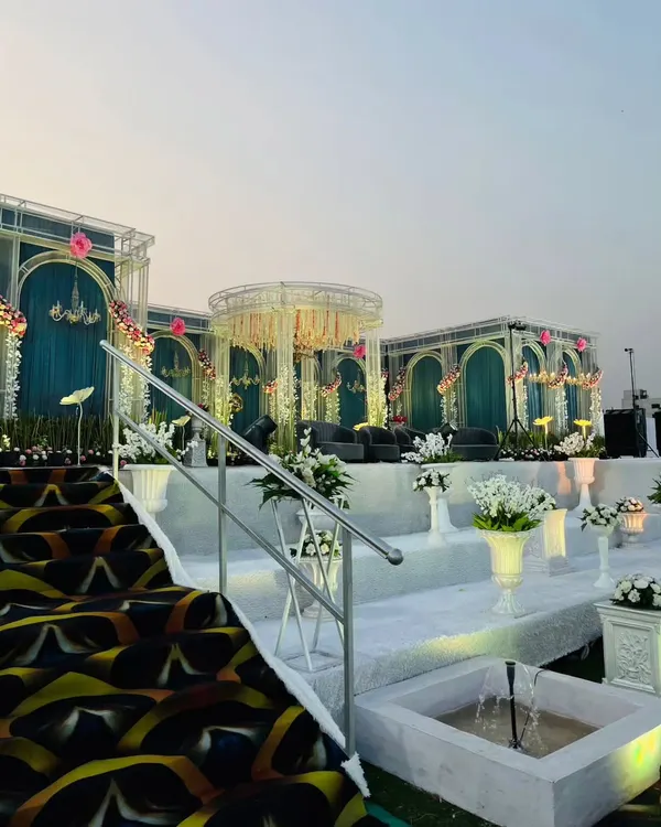 A closer look at the tiered white staircase and integrated fountains leading up to the main stage. This design adds depth and a sense of grandeur, making the approach to the stage an experience in itself.