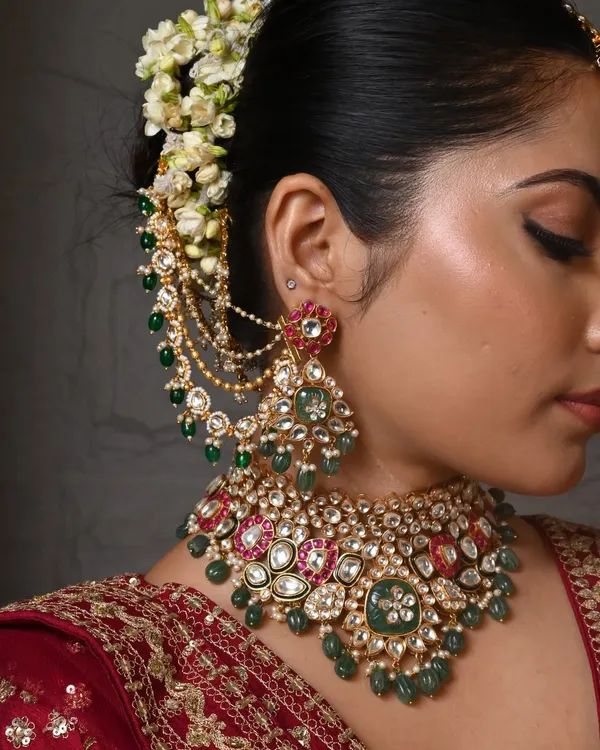 A close-up of one of my favorite bridal sets. The intricate work combines large Polki stones with drops of emerald and ruby-colored beads, complete with matching earchains for a truly regal look.