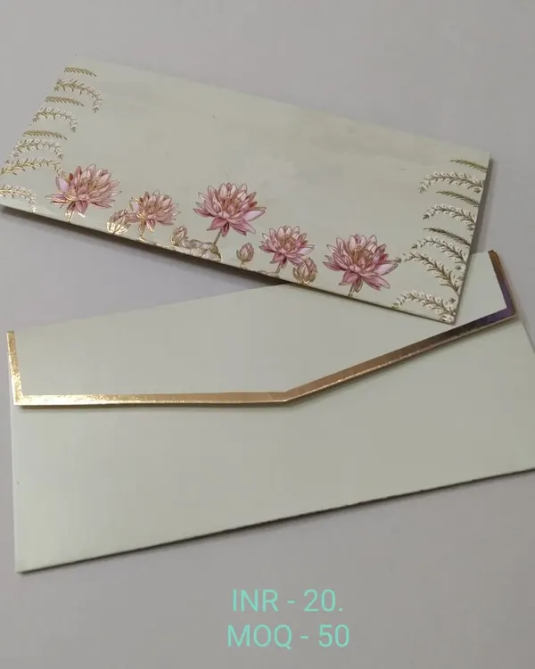 A shagun envelope depicting a serene garden scene with palace domes and lush trees against a sky-blue background. The gold foil accents highlight the architectural details.