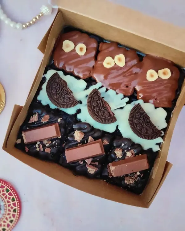 My assorted brownie box is always a hit. This box includes three of my most-loved flavors: rich Nutella Hazelnut, creamy White Chocolate-Oreo, and crunchy KitKat brownies, all freshly baked and ready to be gifted.