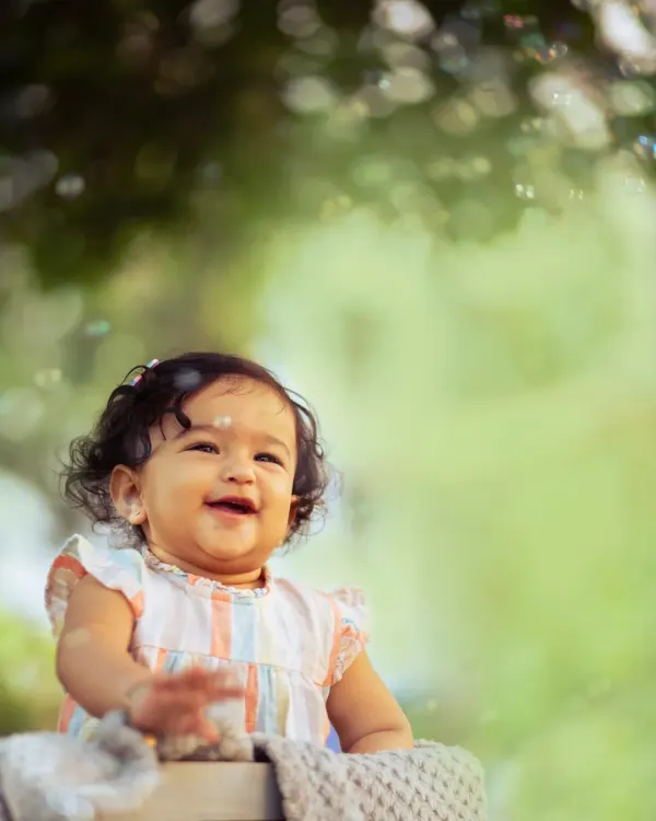 This is what pure joy looks like. I believe the best photos happen when kids are just being themselves, surrounded by nature and happiness. This beautiful, genuine smile is exactly the kind of moment I aim to capture in my outdoor child portrait sessions.