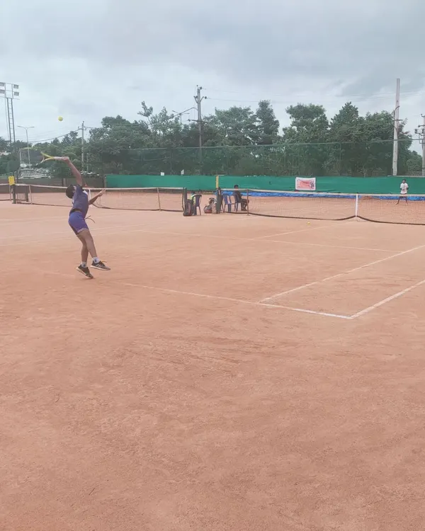 A young competitor executes a serve during the AITA TS7 U-14 tournament hosted at my academy.