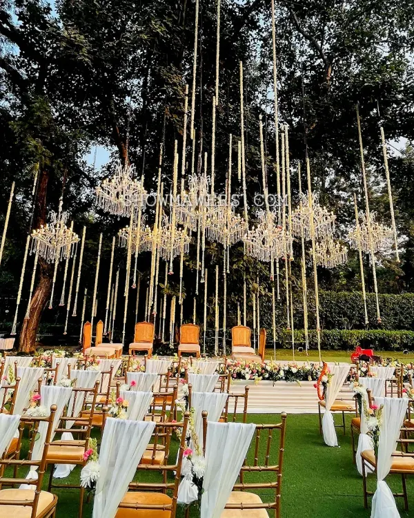 We designed this spectacular open air mandap to feel like a modern fairytale. The combination of suspended golden rods and crystal chandeliers under a canopy of ancient trees created a truly magical setting for the wedding ceremony at Amaara Farms.