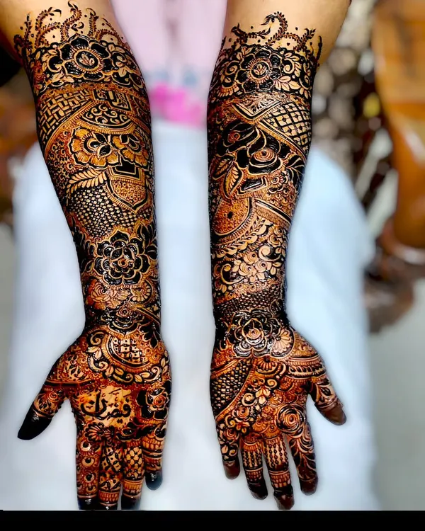 A full-arm bridal design showcasing incredible detail. Notice the names of the bride and groom intricately woven into the pattern, a personal touch I love to add.
