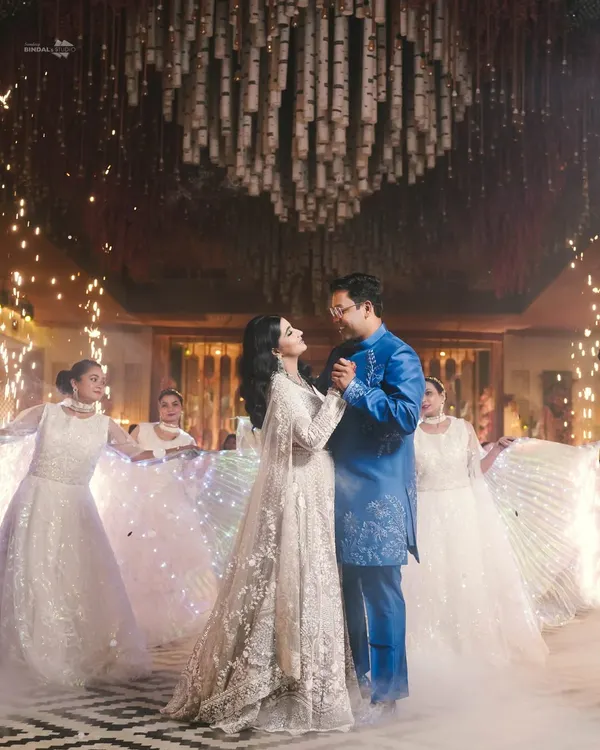 A fairytale first dance. The couple is surrounded by dancers in illuminated dresses and a shower of sparklers, creating a truly magical and cinematic moment for their reception.