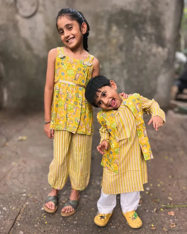 (Hero Item) This is what pure joy looks like. I design my sibling sets so that your little ones can share smiles, hugs, and adventures in outfits that are as comfy as they are cute. This matching yellow set is made from the softest cotton, perfect for festive fun without any fuss.
