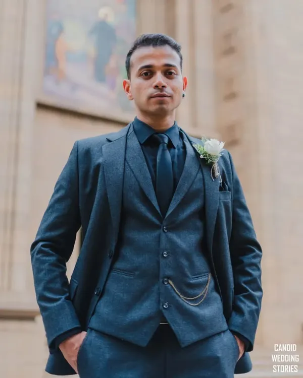 A sharp and stylish portrait of the groom in his three-piece suit, looking confident and ready for his wedding day.