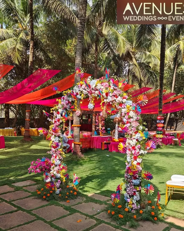 We design immersive experiences, like this spectacular floral archway that creates a vibrant, joyful entrance for an outdoor Mehendi. The combination of colorful drapes and a dense floral arrangement sets a festive and welcoming tone for the celebration.