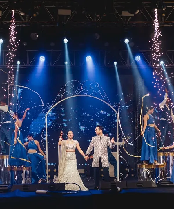 A grand entry is just the beginning. We designed this moment with an archway prop, ribbon dancers, and perfectly synchronized backup performers to create a royal welcome for the couple.