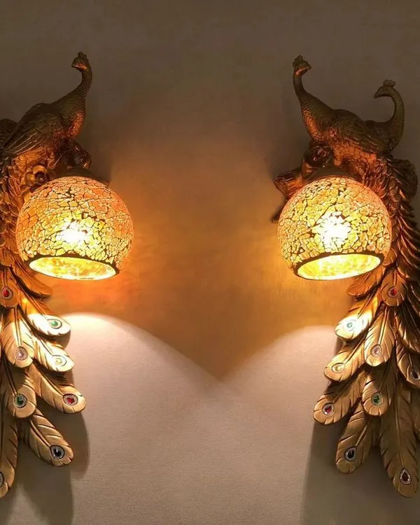 A pair of my golden peacock sconces creates a stunning symmetrical display. The warm light filters through the mosaic glass globe, highlighting the intricate feather details and casting a magical glow.