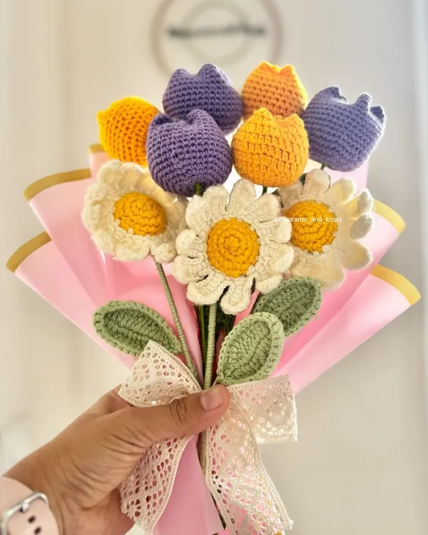 This beautiful custom bouquet was a special birthday gift for a best friend. I combined cheerful white daisies with purple and yellow tulips, all wrapped in pink paper with a lace bow to create a truly personal and everlasting present.