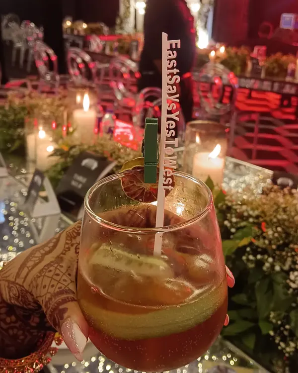 The little details matter. We offer personalized drink stirrers with your wedding hashtag, like this 'EastSaysYesToWest' stirrer, making every cocktail a part of your story.
