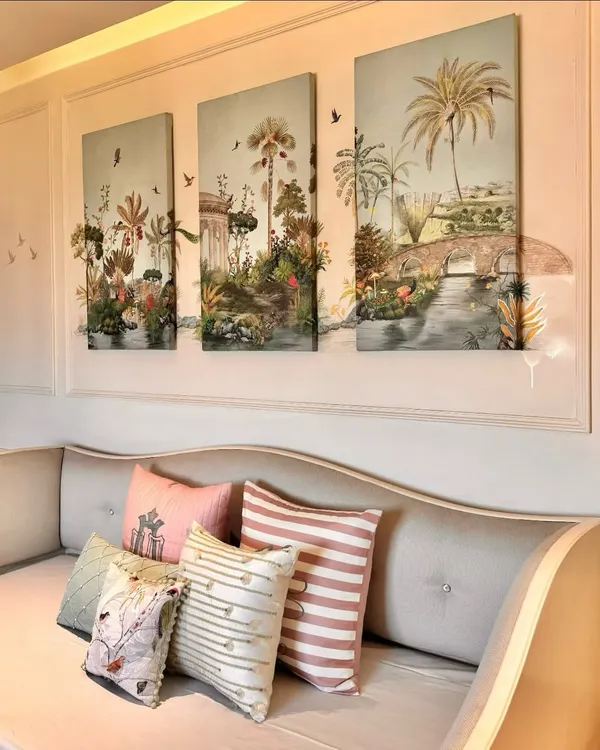 This triptych of hand-painted canvas panels brings a lush, tropical garden scene indoors. The soft palette and detailed flora create a calming and charming focal point above the daybed, complemented by my custom cushions.