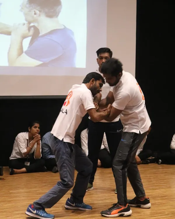 Demonstrating a wrist lock and control technique at a self-defence workshop for over 250 girls at GL Bajaj college.