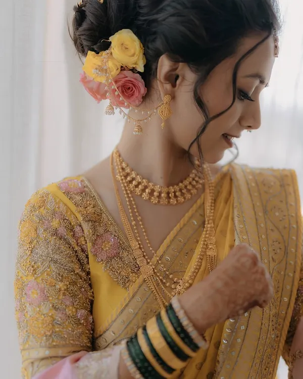 A close-up of my bride Krupali's wedding look, with a beautiful floral bun and traditional jewelry.