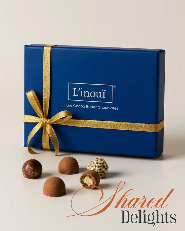 Our classic royal blue gift box, tied with a gold ribbon, featuring an assortment of pure cocoa butter chocolates. It's the perfect way to share delight and make amends for all the snacks you've stolen from your sibling this Rakhi.