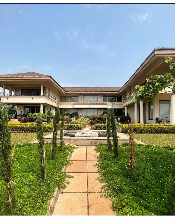Planned on an open H design, this Tuscan architecture inspired home is set on the edge of Kune Plateau. It features a 100 foot-long corridor, expansive lawns, and a central water feature, capturing the essence of a grand Italian villa.