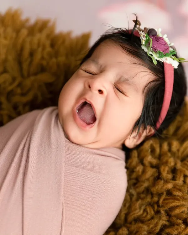 A perfect capture of a newborn's big yawn, showing the candid and authentic moments I look for during a session.