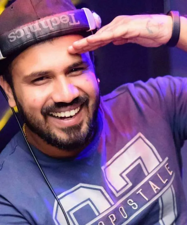 A classic DJ pose, smiling from behind the decks with my Technics headphones. This is my happy place, where I connect with the music and the crowd.