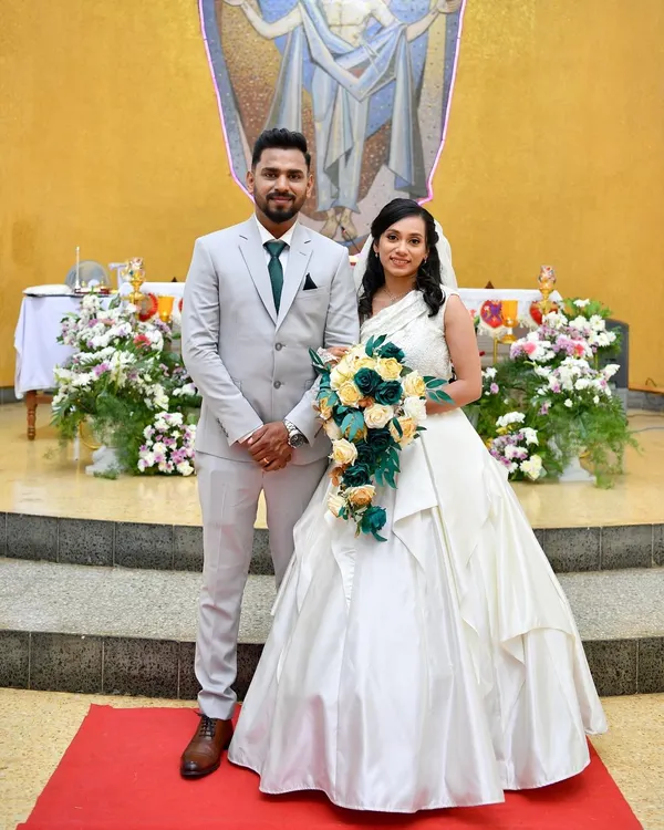 A beautiful Christian bride and groom. I designed and created this elegant one-shoulder white wedding gown for her special day.