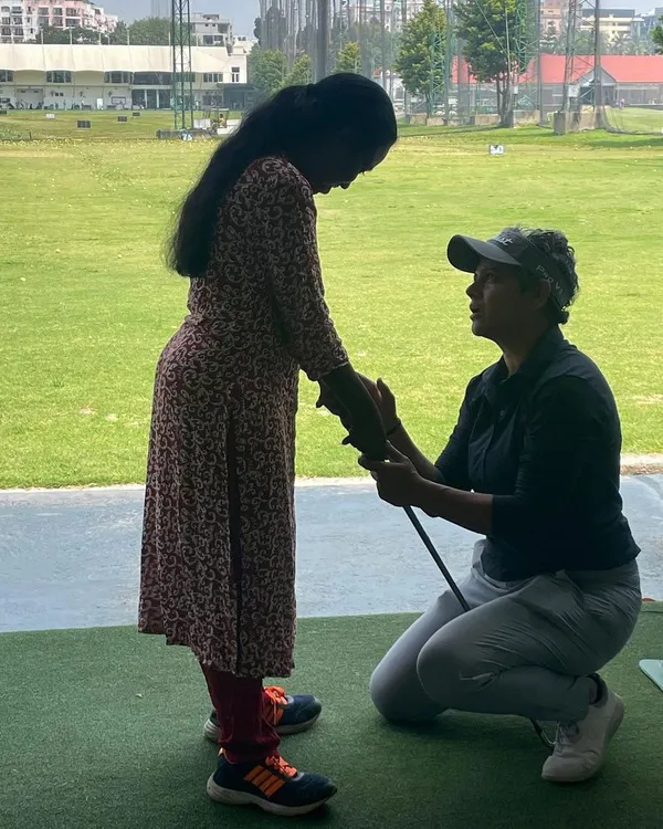 I believe golf is for everyone, and I'm passionate about making it accessible. Here, I'm working with a visually impaired student, using a hands-on approach to help her feel the correct posture and swing path. It's an honor to share this beautiful game.