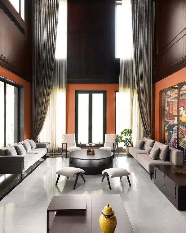This double-height living room is the heart of a heritage home I restored. My goal was to create a space that feels grand yet intimate, balancing bold color with contemporary furniture and traditional art. The design emphasizes scale, natural light, and a seamless connection to the outdoors.