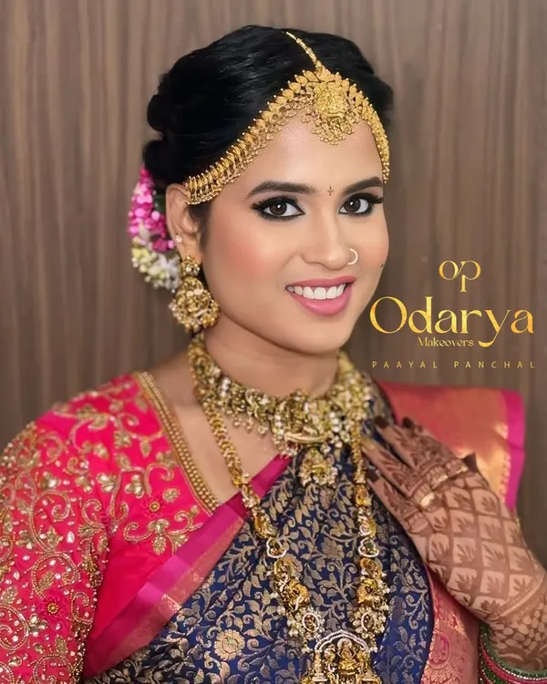 This is the quintessential South Indian bridal look I adore creating. The focus is on flawless, glowing skin, bold eyes defined with a classic winged liner, and a radiant smile, all brought together with traditional temple jewellery.