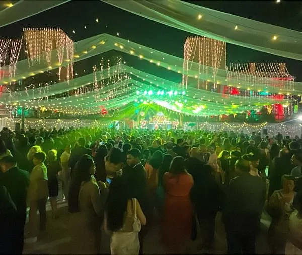 A wide-angle view of a massive crowd under festive lights. This is the kind of atmosphere we create, turning any venue into a vibrant party.