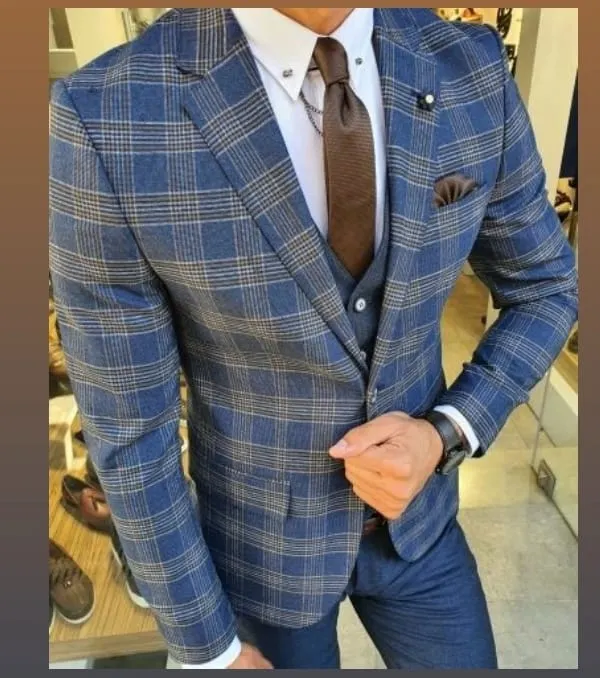 This three piece suit in a blue and tan check pattern is a great example of a modern business look. The waistcoat adds a layer of formality, while the pattern provides a touch of personal style.