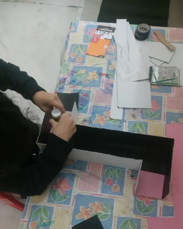 The beginning of a periscope school project. We start by helping the student understand the concept and gather the necessary materials, breaking down a big project into manageable steps.