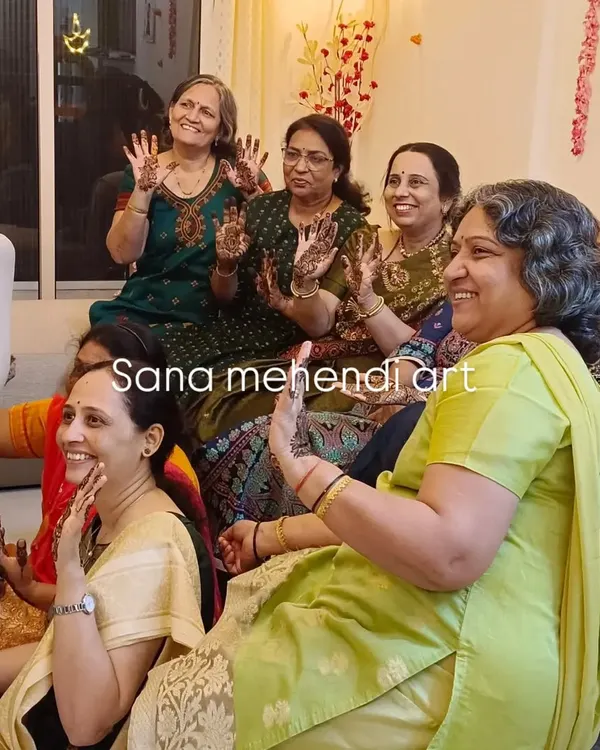 A group of happy clients showing off their mehendi. My team and I are equipped to handle large groups for your mehendi party, ensuring everyone gets a beautiful design.