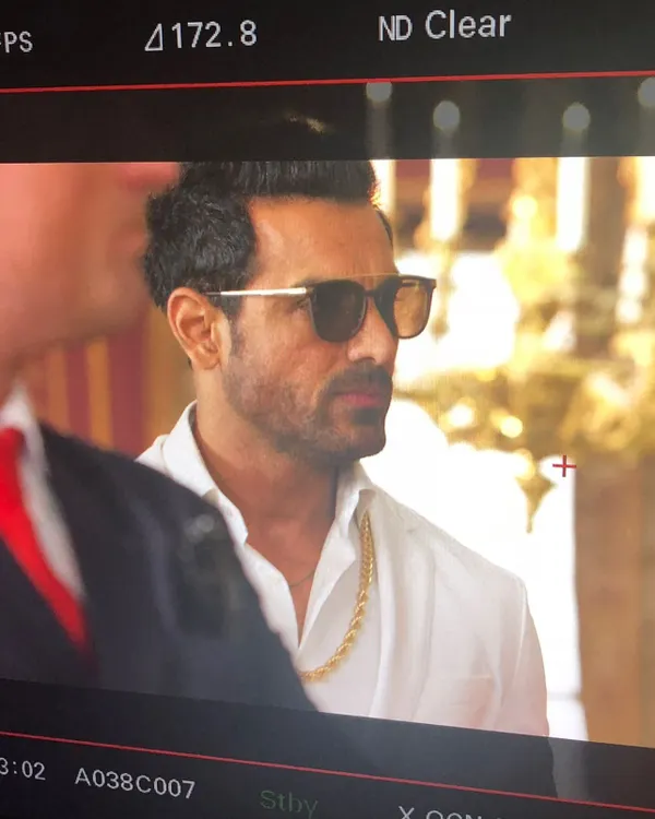 A monitor shot of John Abraham during a shoot. I styled him in this crisp white shirt, gold chain, and sunglasses to create a suave and powerful character look.