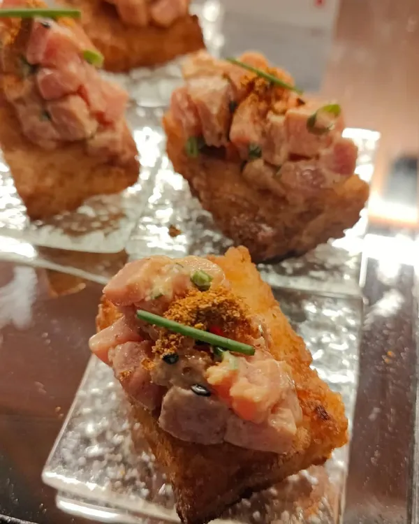 A close-up of our Spicy Maguru Tuna on crispy stick rice. This is one of our most requested small plates, perfectly balancing spice and texture for a memorable bite at any corporate event or private party.
