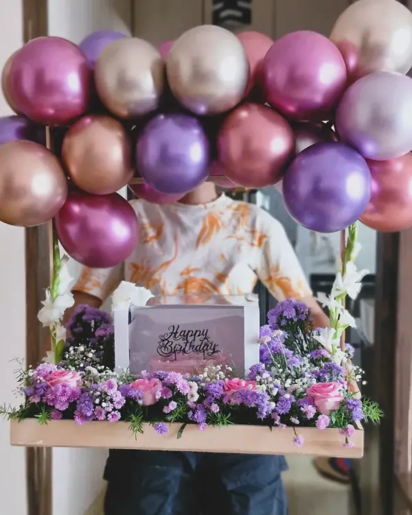 This stunning birthday arrangement combines a delicious cake with fresh, vibrant flowers and festive balloons, creating a complete celebration in one delivery. It’s a perfect example of how I can create a high-impact gift for a truly special day.