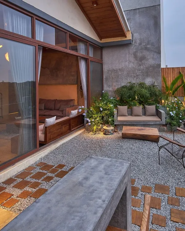 The penthouse terrace is designed as an outdoor living room, seamlessly extending the interior space. We used gravel, wood, and a custom concrete bench to create a rustic, tranquil escape with views of the city.