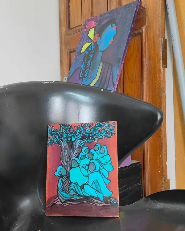 The painting "Wanna hear a story from the branches?" displayed in my studio next to another piece. Seeing my works in conversation with each other is always interesting.