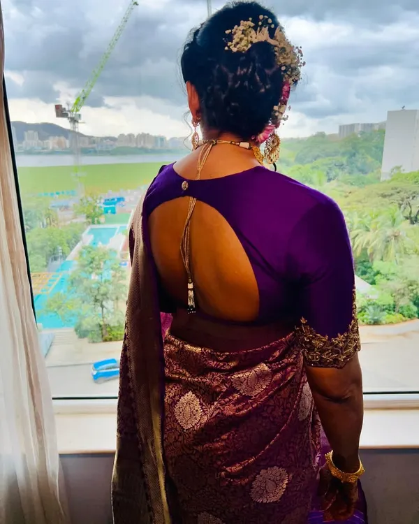 A soft glam look with a traditional braided bun for this beautiful client. This back shot shows the intricate hairstyle and how it complements the stunning purple saree.