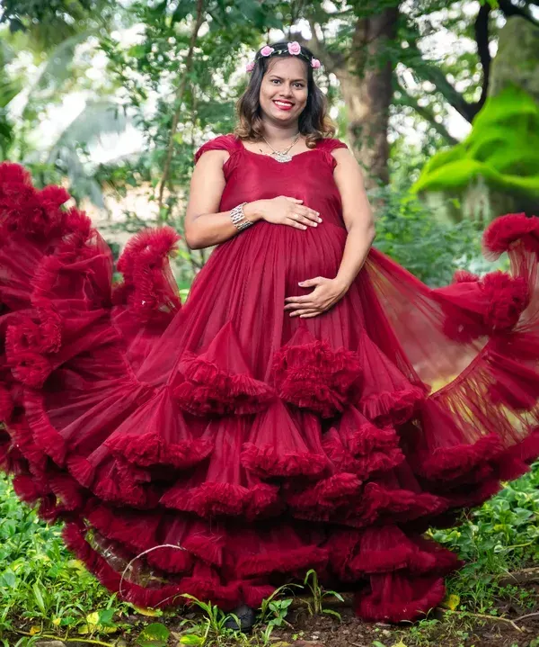 This is what the pregnancy glow is all about. I love using dramatic, flowing gowns like this vibrant red one to create stunning solo portraits that celebrate the power and beauty of motherhood amidst nature.