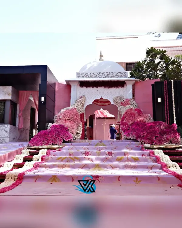 A wide view of the magnificent entrance I constructed for an Anand Karaj. The design features a Gurdwara inspired dome, a custom printed aisle, and a lavish display of pink and white flowers, creating a truly grand and memorable path for the couple.
