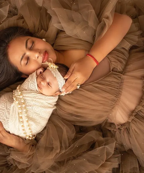 A truly angelic portrait of a mother and her newborn. Lying amidst a sea of soft brown fabric, this shot is all about peace, love, and that incredible bond.