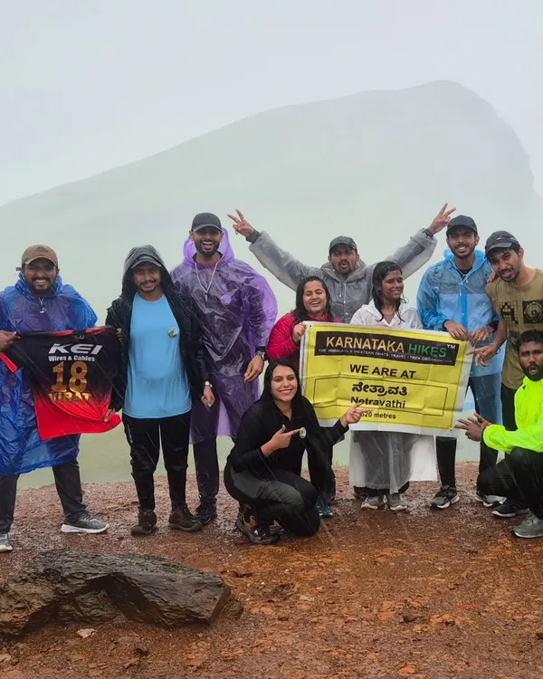 Our trek family at Netravati Peak, proudly showing our RCB and Karnataka spirit. This is the vibe we bring to the mountains!