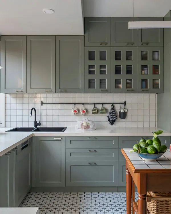 The kitchen is the heart of every home. In this Calcutta residence, we used calming sage green cabinetry, classic white tiles, and patterned flooring to create a space that is both welcoming and functional. The design honors the local love for home-cooked food and shared moments.