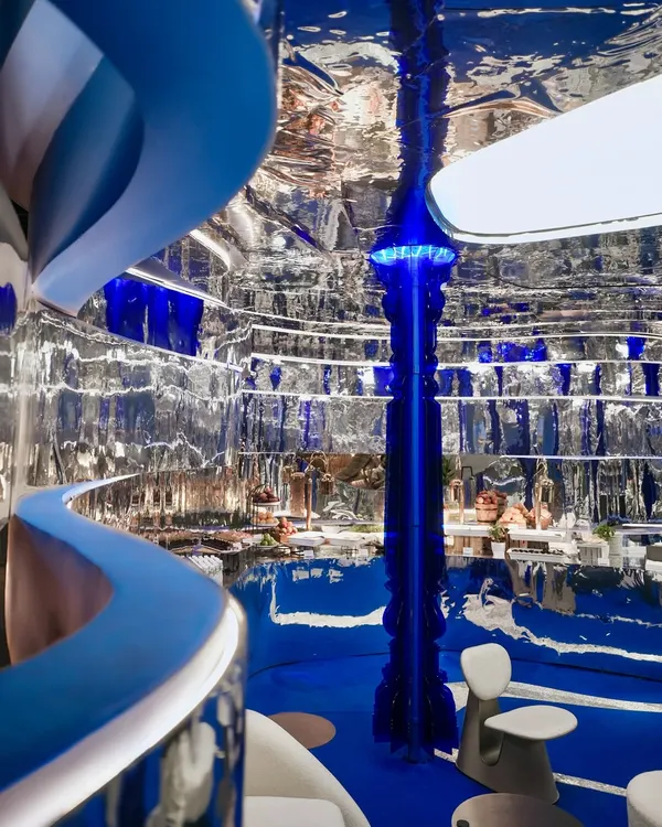 We believe in creating spaces that are more than just seen, they are felt. Here, in our 'Mercury' installation, liquid chrome walls and cobalt blue floors create a futuristic cocoon, a world where light bends and reflections tell a new story with every glance. This is where architecture becomes an interactive experience.