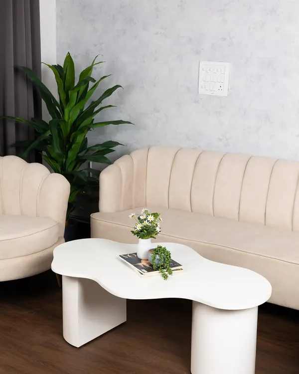 This wider view shows our main lounge set, featuring the fluted sofa and armchair against the textured grey wall. It’s a perfect setup for interviews, portraits, or lifestyle brand shoots.