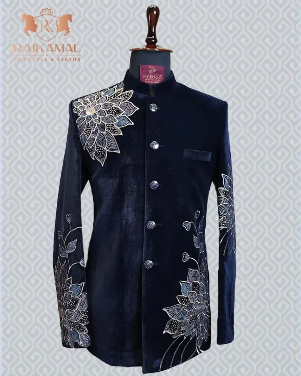 This navy blue velvet Jodhpuri suit is the epitome of class. The detailed floral embroidery on the shoulder and sleeve adds a touch of artistry to its regal design.