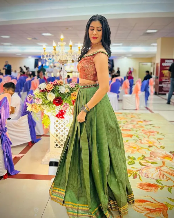 A heartwarming transformation. We took our client's mother's traditional saree and repurposed it into this stylish off-shoulder crop top and pleated lehenga skirt. It’s a beautiful way to honor family heritage while creating a new, modern look.